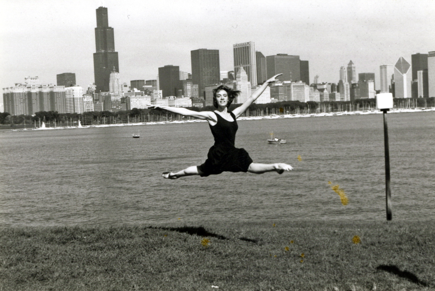 Woman leaping with Chicago skyline in background