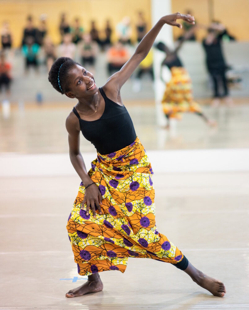 Young dancer in colorful skirt