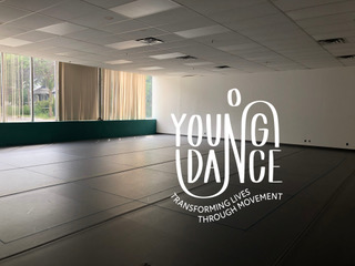 Photo of a dance studio with windows at the far wall